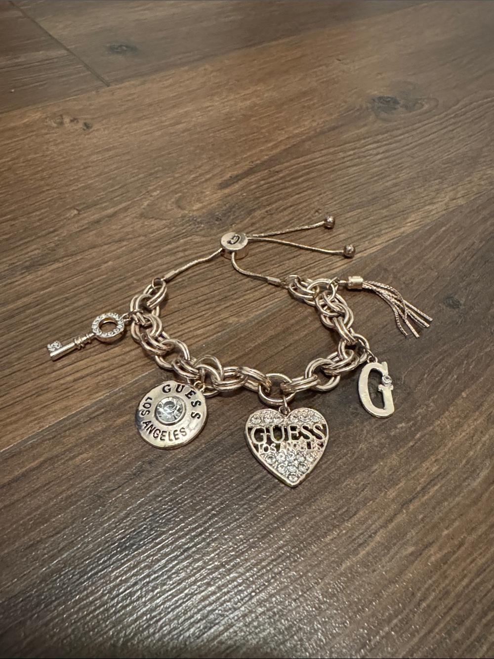 GUESS Gold Tone Charm Bracelet Pave Rhinestone